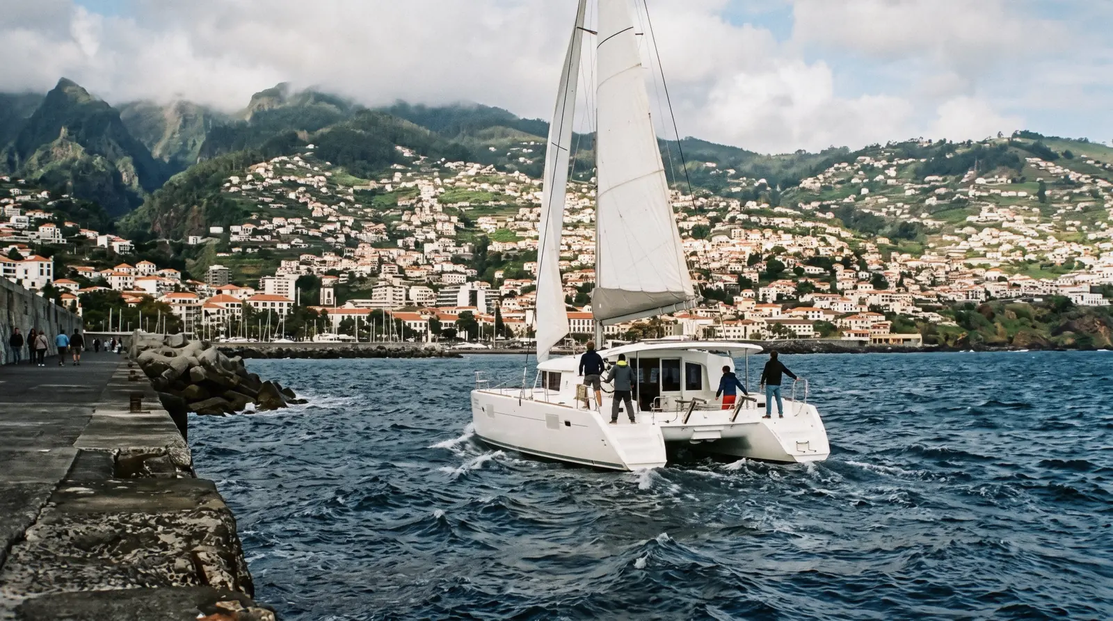 View over the amphitheatre of Funchal, Madeira, with red rooftops, the marina and the hills above the city on a three day Funchal itinerary