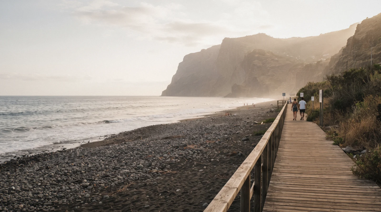 Waves breaking on the pebble and black sand shore of Praia Formosa in Sao Martinho, Funchal, Portugal