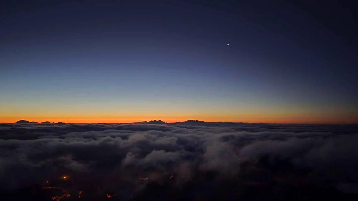 The sun rising over a sea of clouds seen from the summit of Pico do Arieiro on a Madeira sunrise tour in Pico do Arieiro, Madeira, from Funchal, Portugal