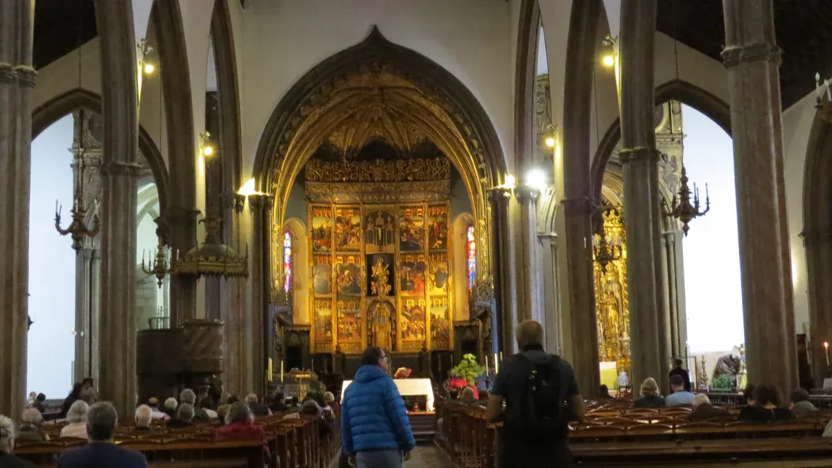 The nave, gilded altarpiece and dark wood ceiling of the Se do Funchal cathedral in Funchal, Madeira, Portugal