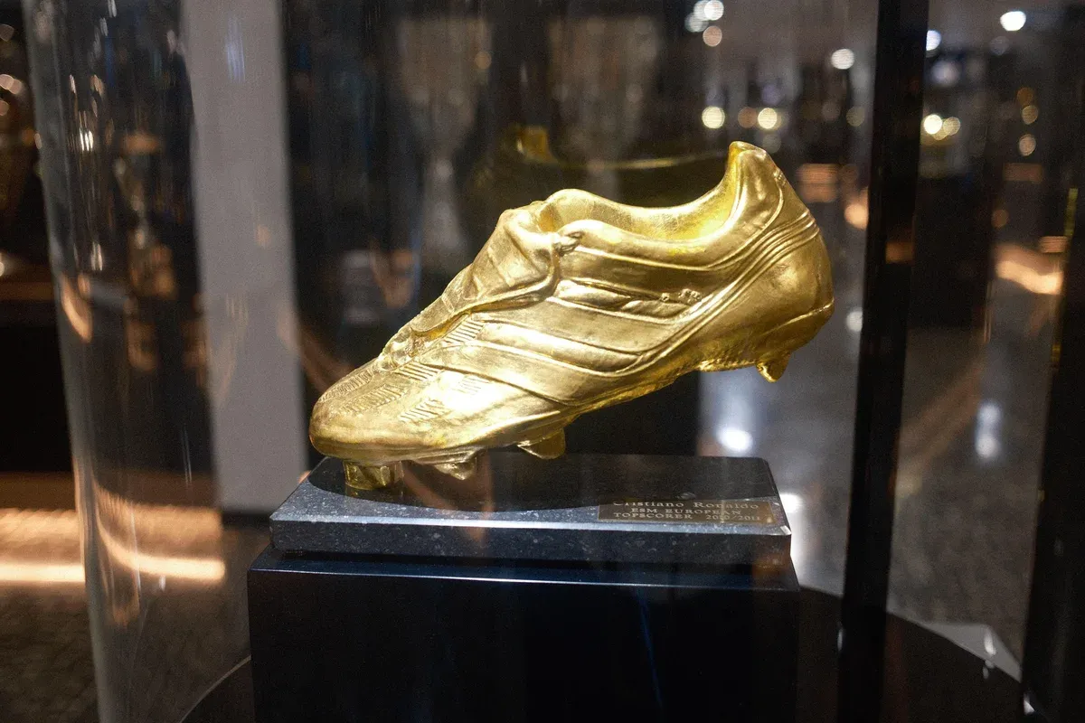 A gold-plated boot trophy displayed in a glass case inside the CR7 Museum in Funchal, Madeira, Portugal