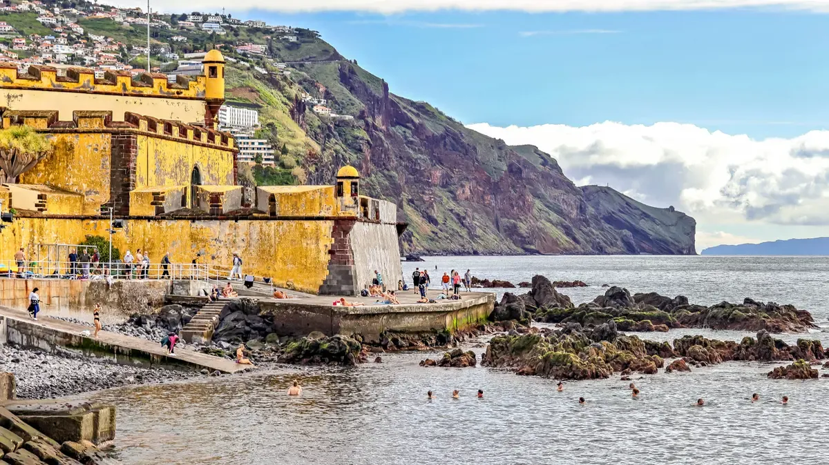 The yellow ochre bastion of the Sao Tiago fort beside the sea at the end of the Funchal old town, Madeira