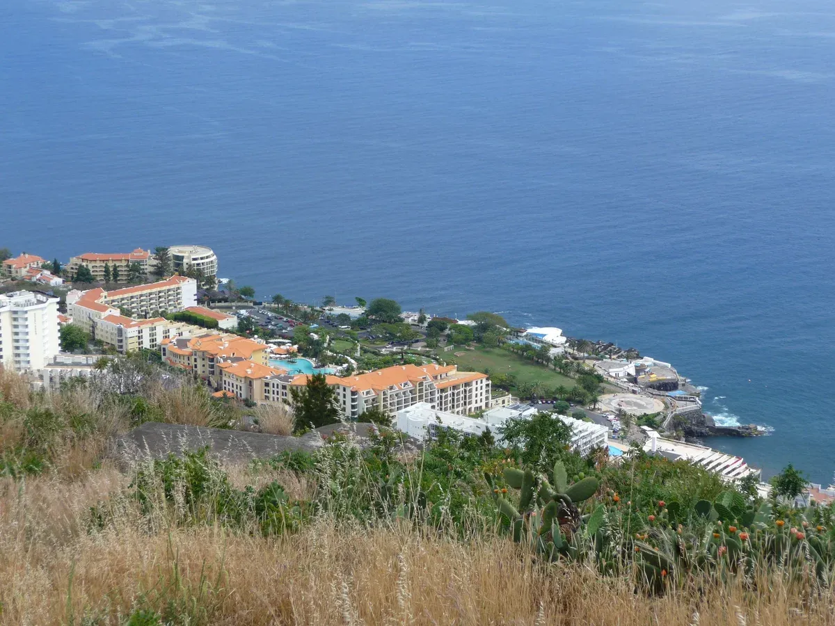 Hotel buildings and swimming pools along the clifftop of the Lido hotel zone in Funchal, Madeira, above the Atlantic