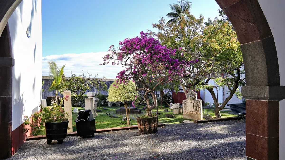 The garden courtyard of Quinta das Cruzes museum with a flowering tree, Funchal, Madeira