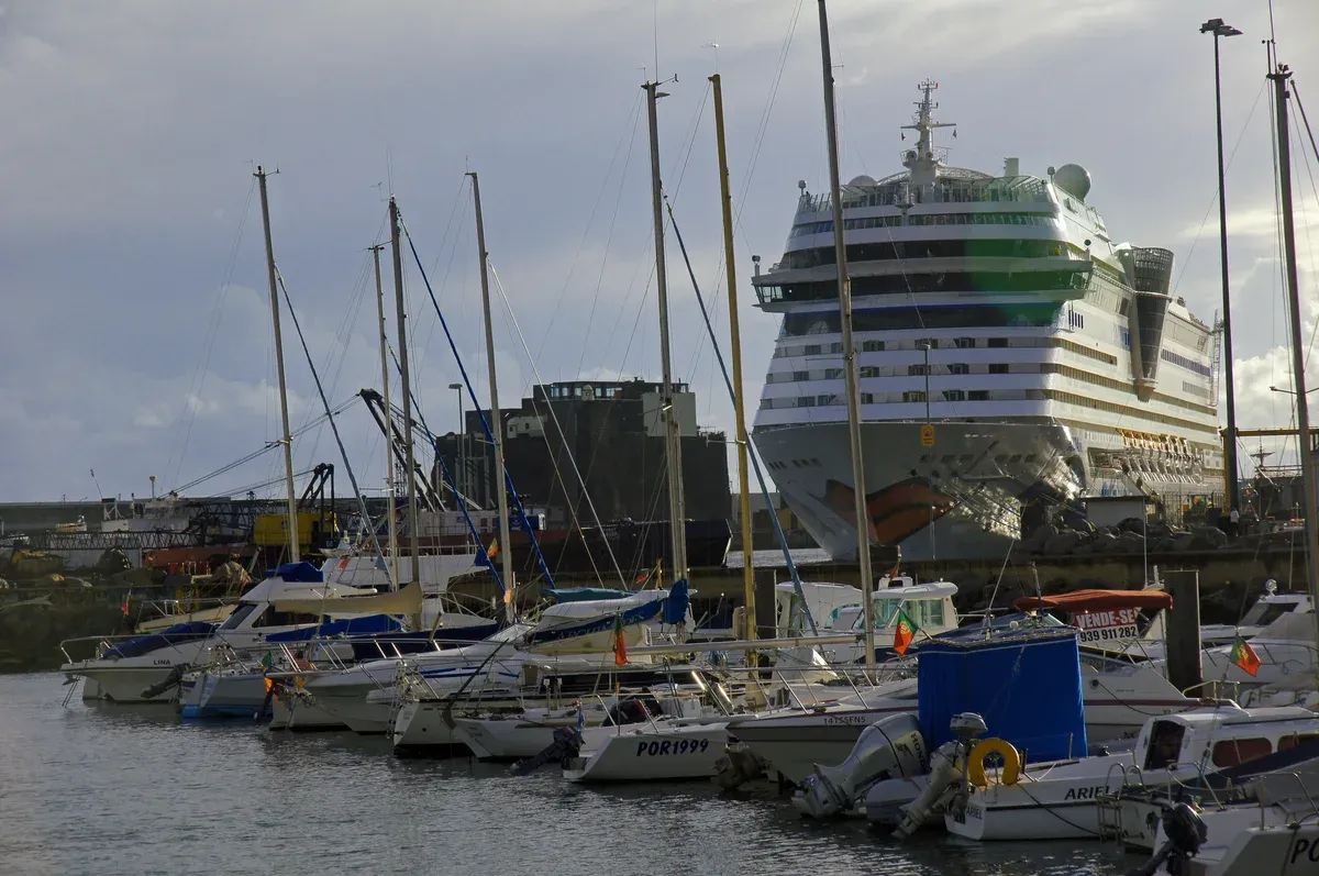 Sailboats and a cruise ship docked at the Funchal marina where the old town and city centre neighbourhoods meet, Madeira
