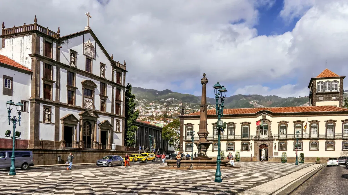 The calçada mosaic pavement, fountain and city hall building on Praça do Município in central Funchal, Portugal