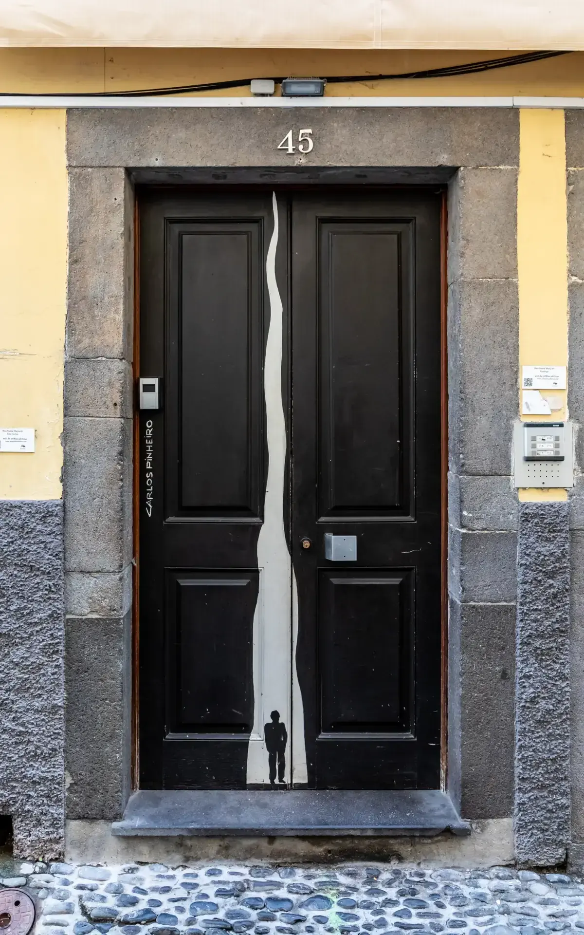 A painted black door numbered 45 on Rua de Santa Maria near the Madeira Story Centre in Funchal's old town, Portugal