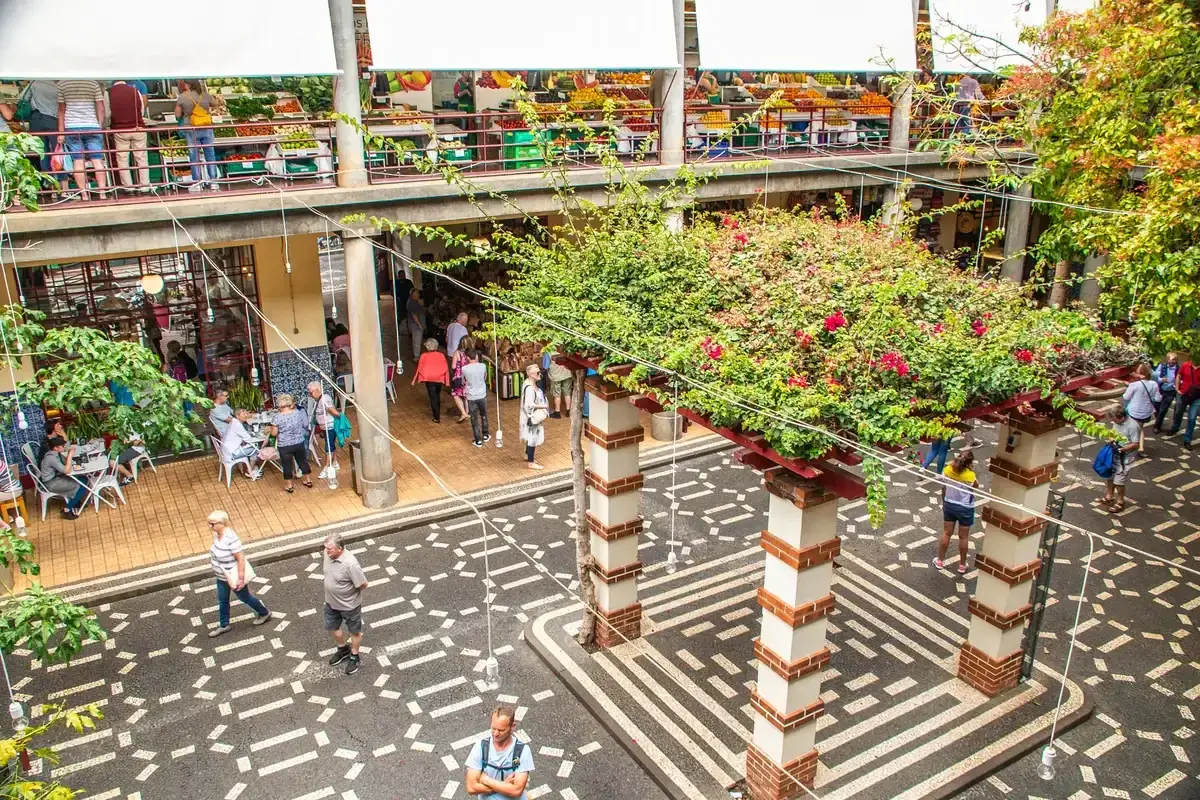 The upper fruit stalls and ground-floor cafe terrace inside the Mercado dos Lavradores in Funchal, Madeira